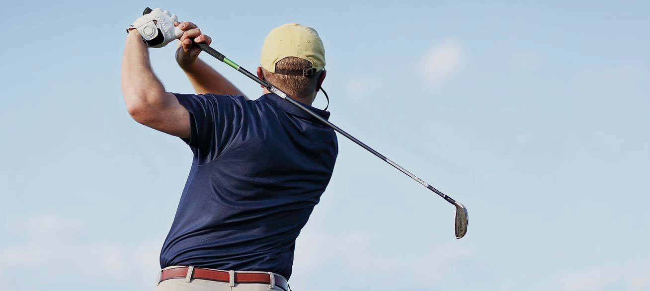 Man playing golf. Pavilions Blackburn Lake is near four major golf courses