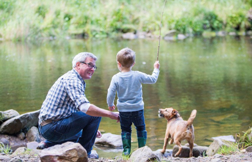 Senior man with young boy and dog playing beside a river. Enjoy the natural environment with Blackburn Lake Sanctuary across the road and many parks nearby.